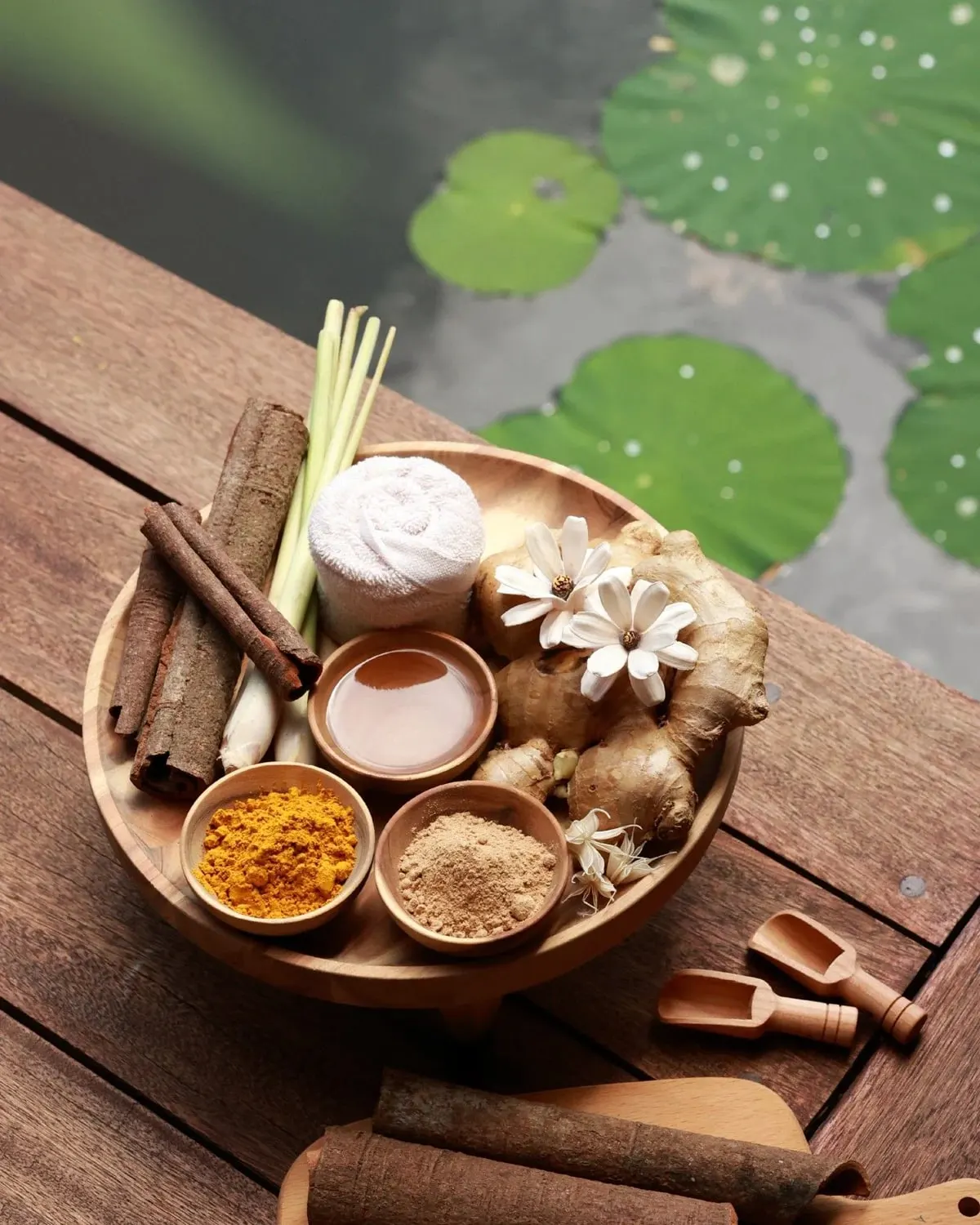 Natural spa ingredients by a lotus pond